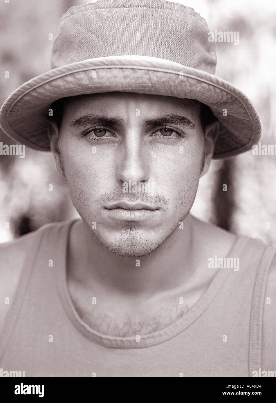 Portrait of a young man facing the camera wearing a sun hat Stock Photo