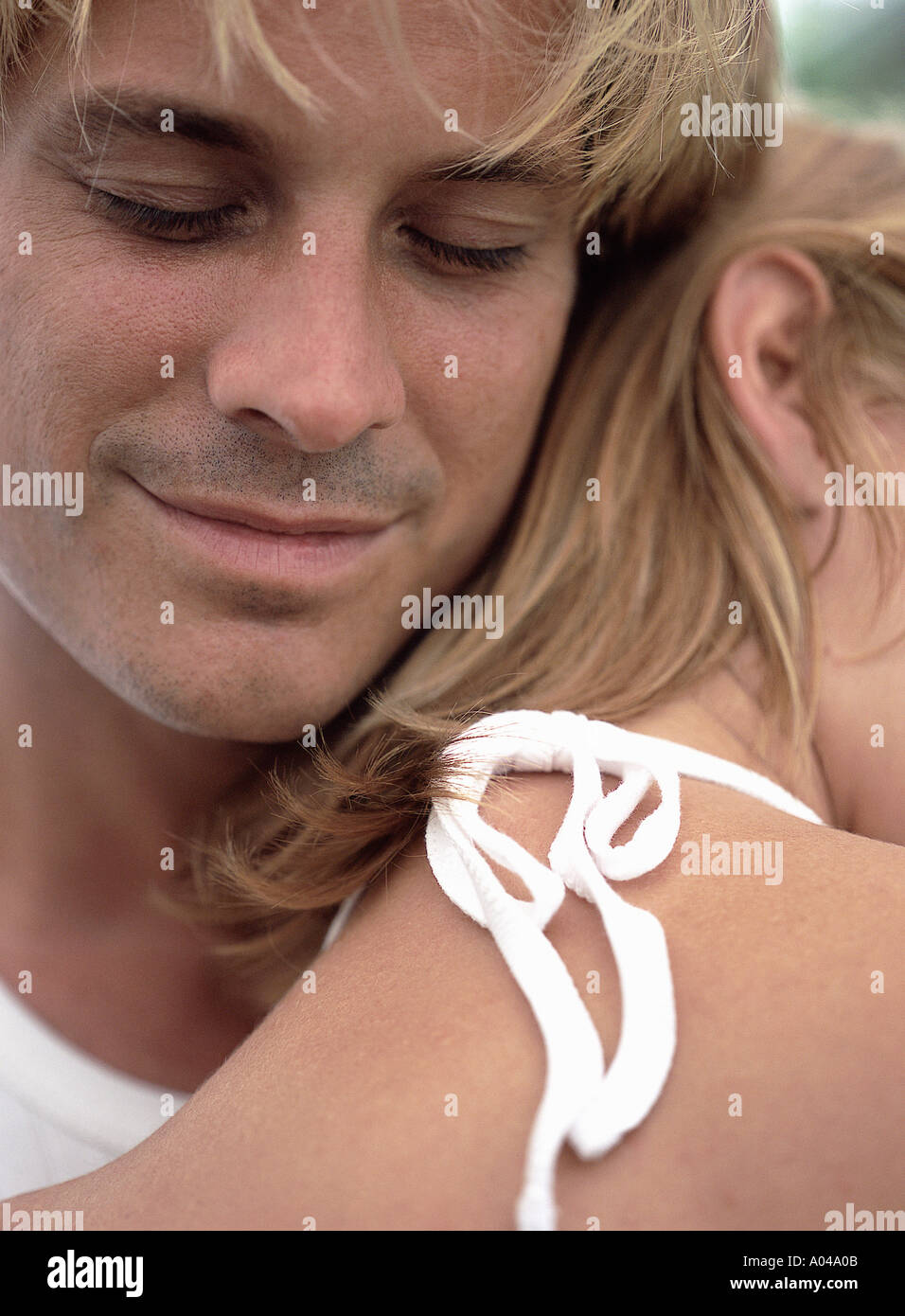 Young couple resting their heads together in an intimate embrace Stock Photo