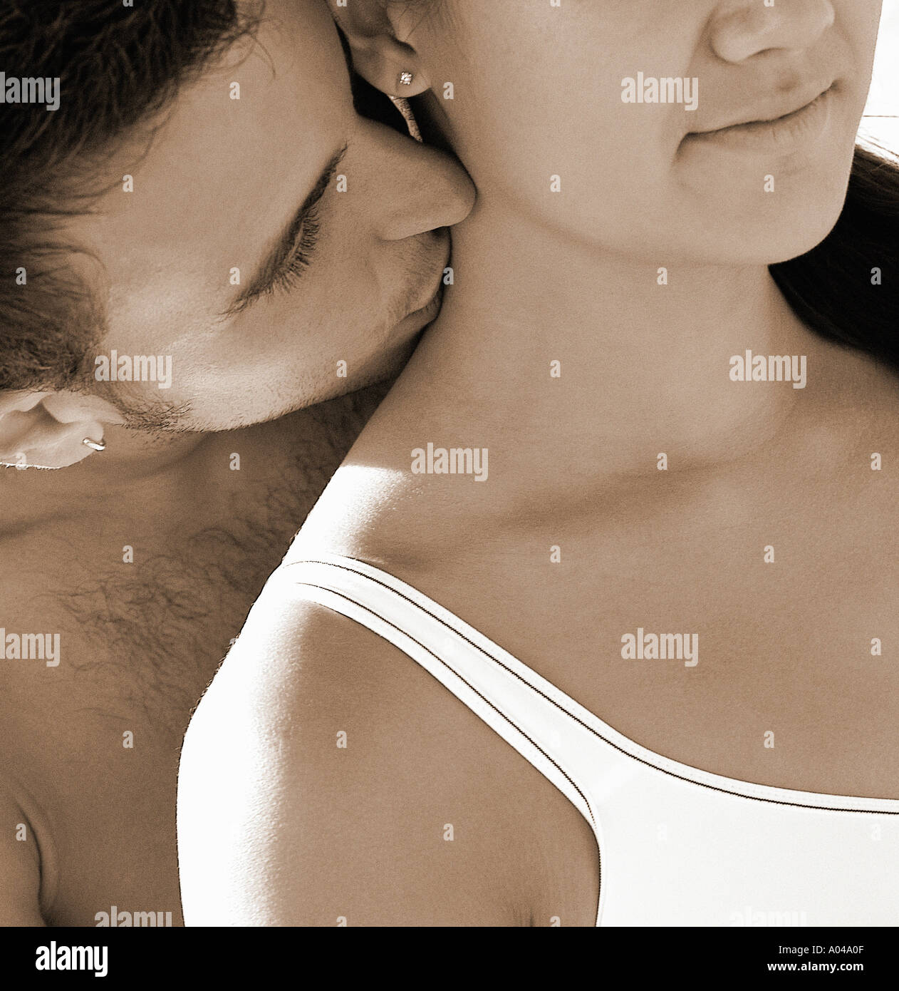 Young man kissing the neck of a young woman Stock Photo