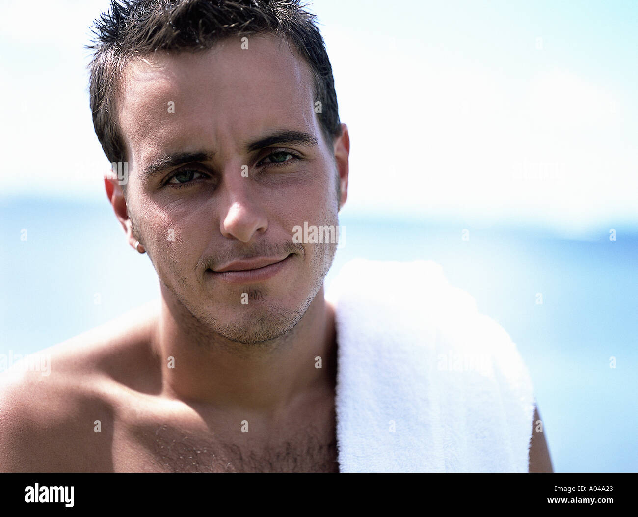 Portrait of young man with a towel over his shoulder  smiling Stock Photo
