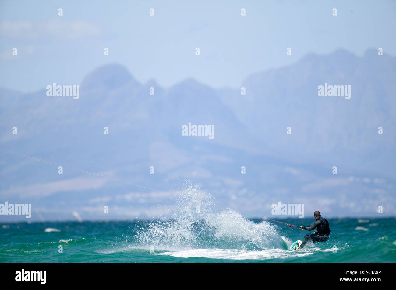 South Africa Western Cape Province Cape Town MR Kite surfer rides through breaking waves at Fish