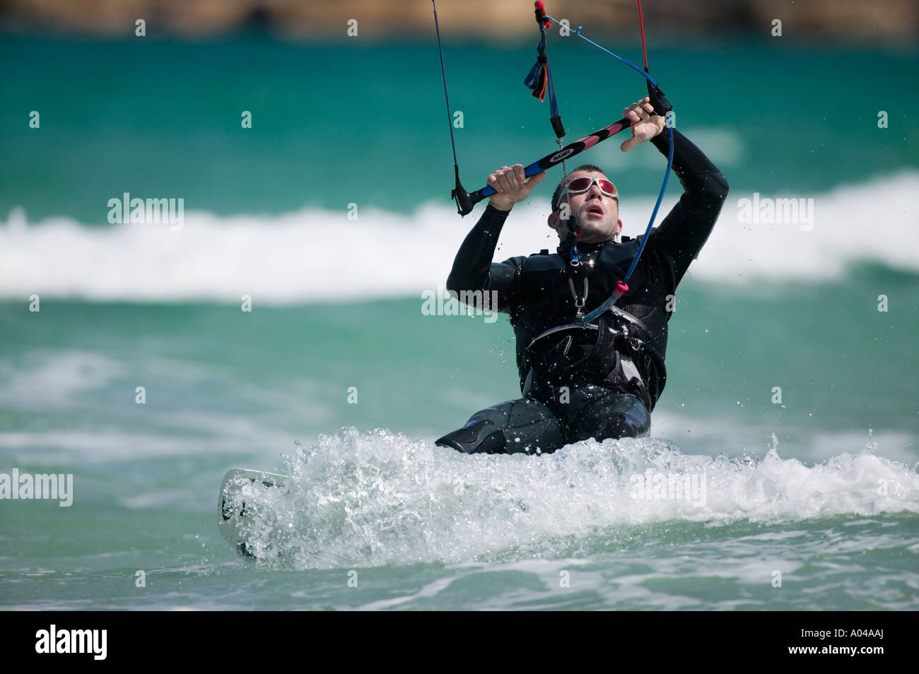 South Africa Western Cape Province Cape Town MR Kite surfer rides through breaking waves at Fish