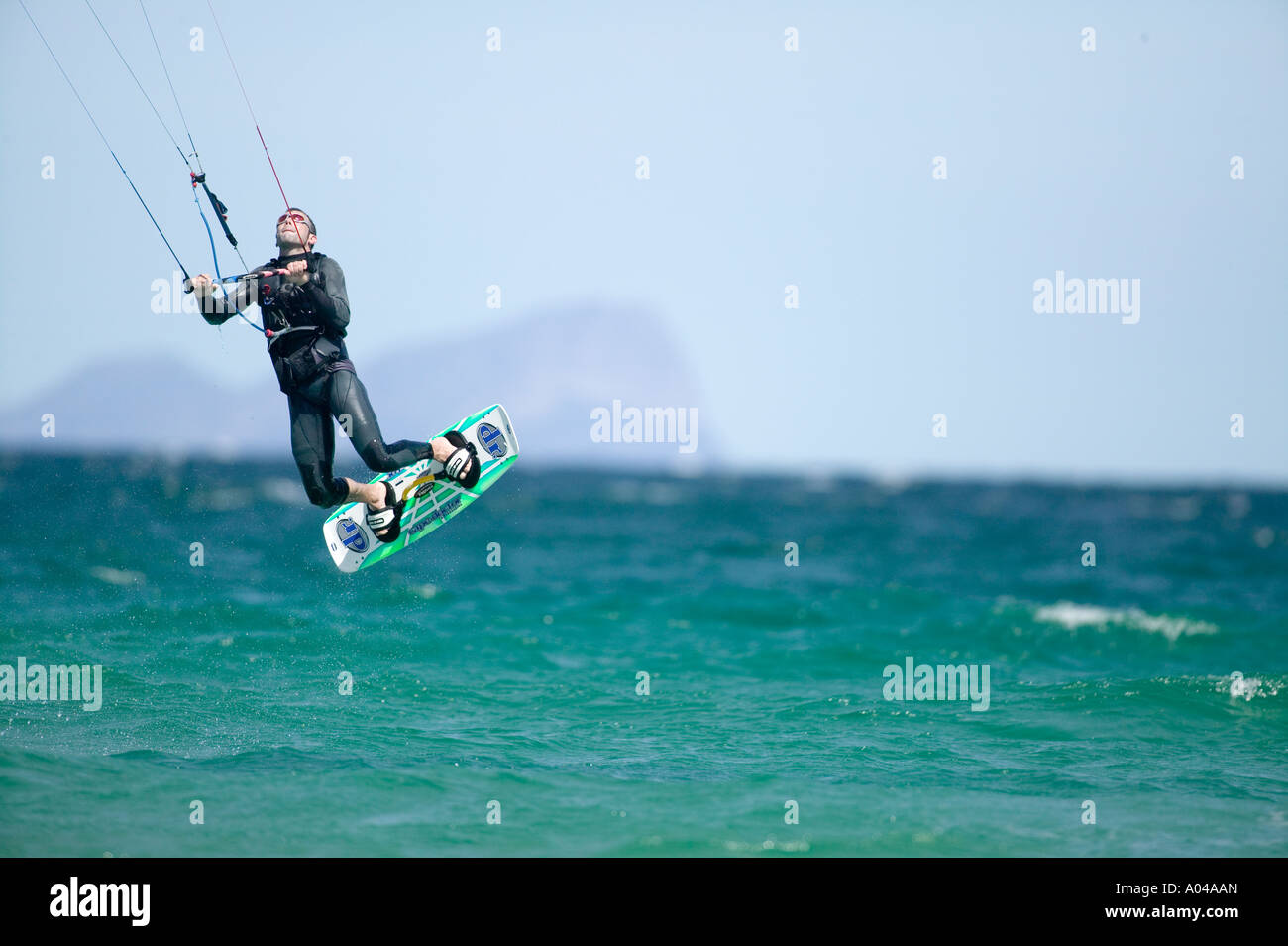 South Africa Western Cape Province Cape Town MR Kite surfer rides through breaking waves at Fish