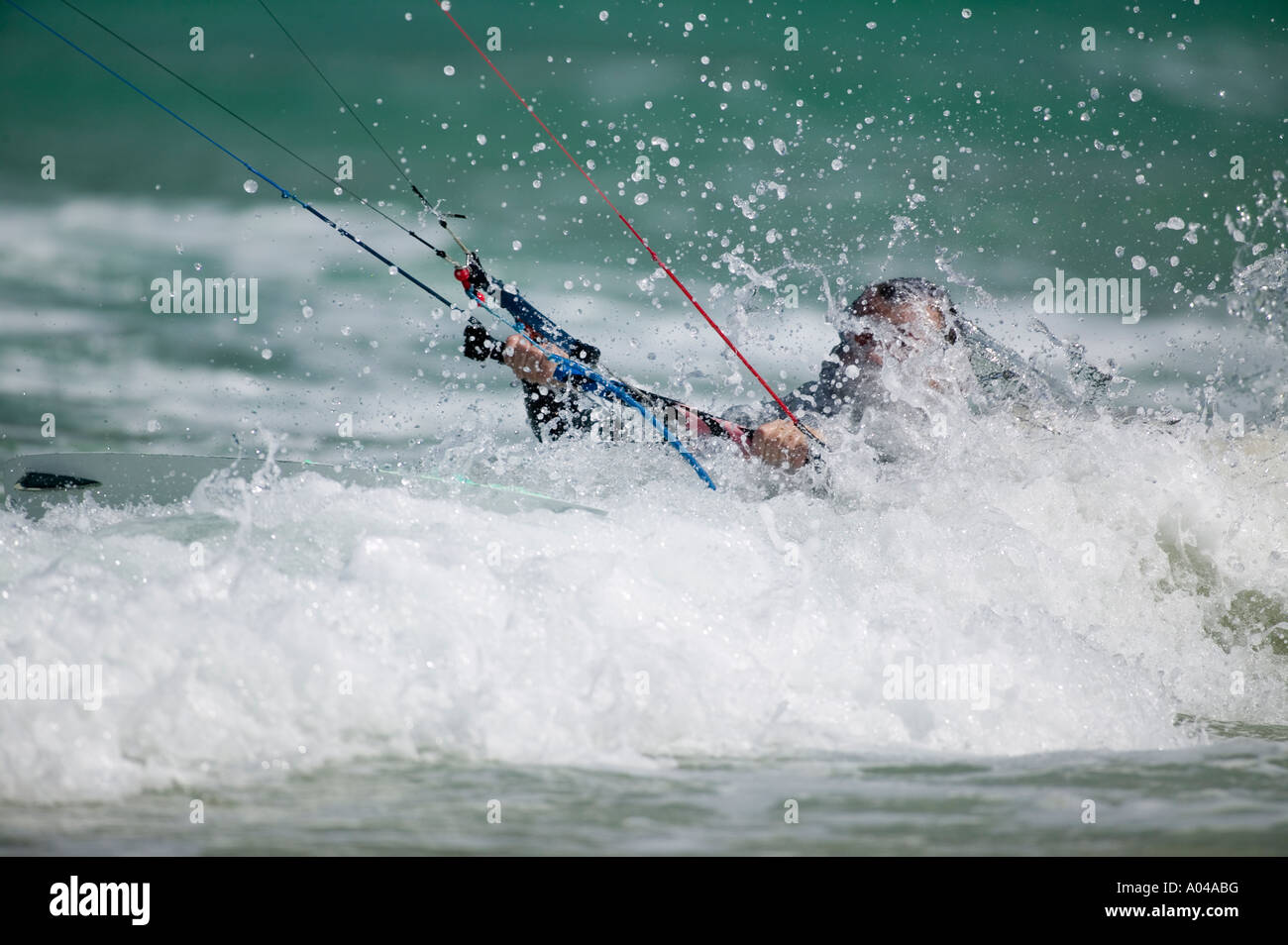 South Africa Western Cape Province Cape Town MR Kite surfer rides through breaking waves at Fish