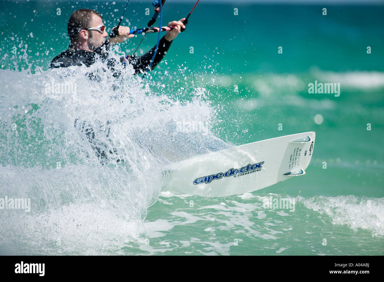 South Africa Western Cape Province Cape Town MR Kite surfer rides through breaking waves at Fish