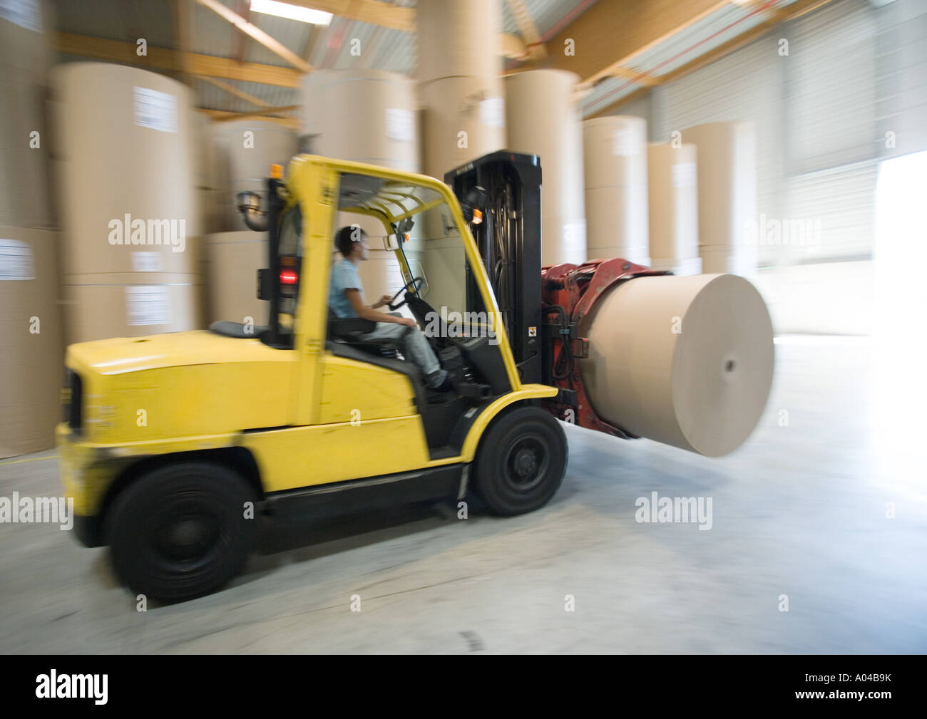 Fork lift carrying roll of paper Stock Photo