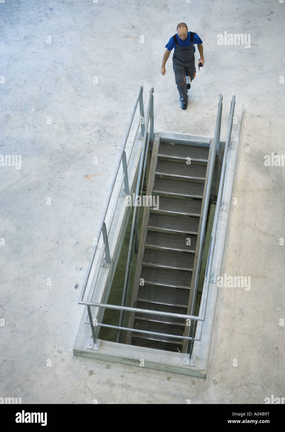 Factory worker approaching stairs Stock Photo Alamy