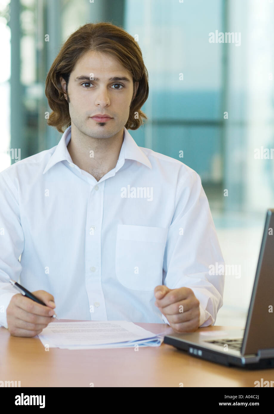 Young male executive working at desk Stock Photo
