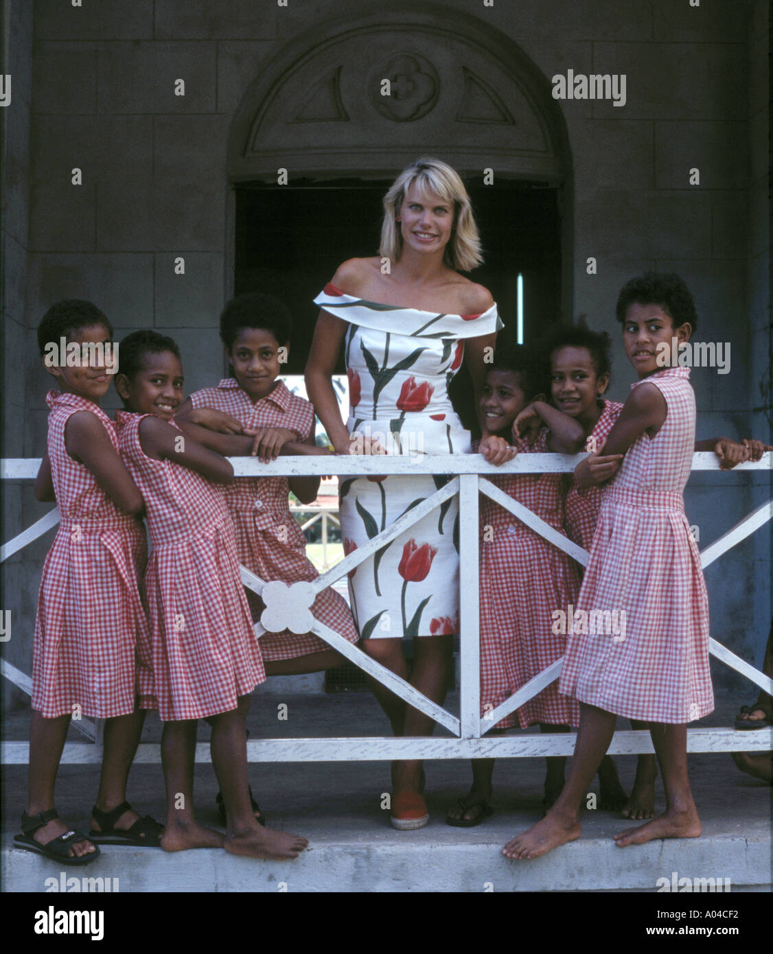 TV Presenter Anna Walker in Fiji with uniformed schoolgirls. Stock Photo