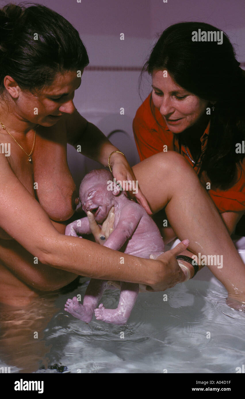 A midwife assists a mother with a new born baby during a water birth in Sydney Australia- NB PHOTO  FOR POSITIVE USAGE ONLY! Stock Photo