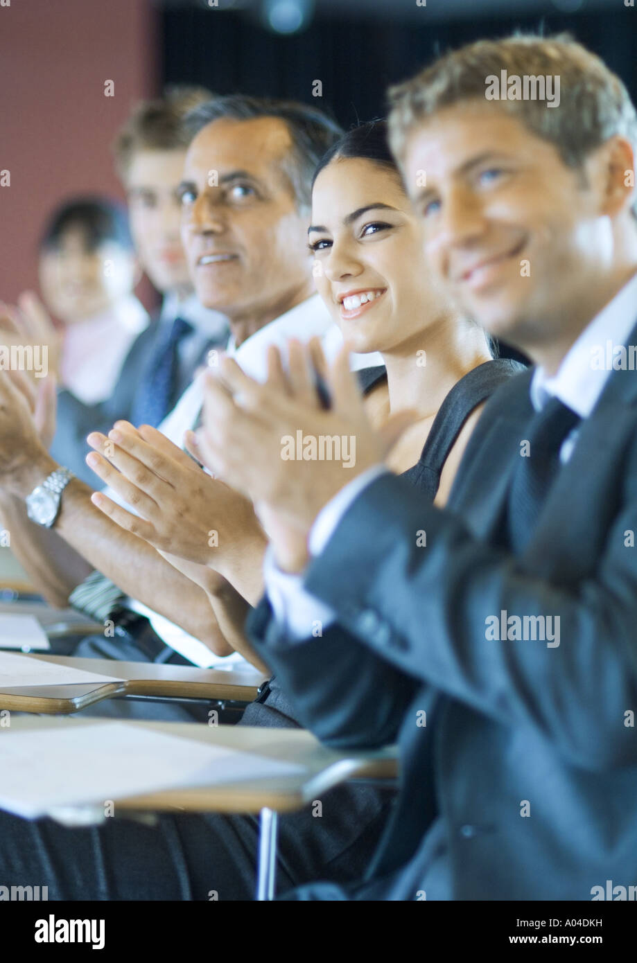 Executives sitting in seminar, clapping Stock Photo