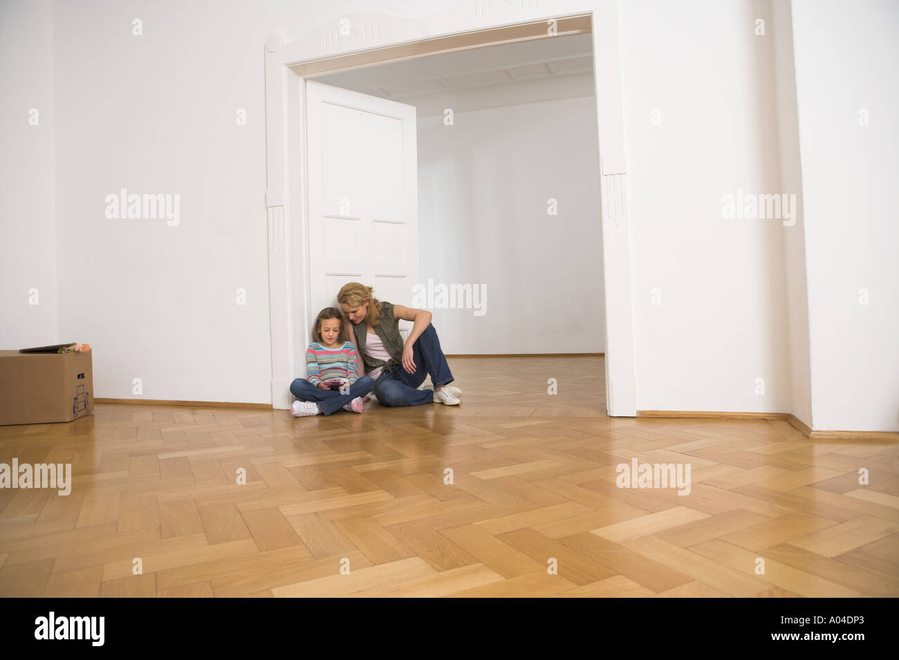 mother and daughter taking a break from moving home Stock Photo