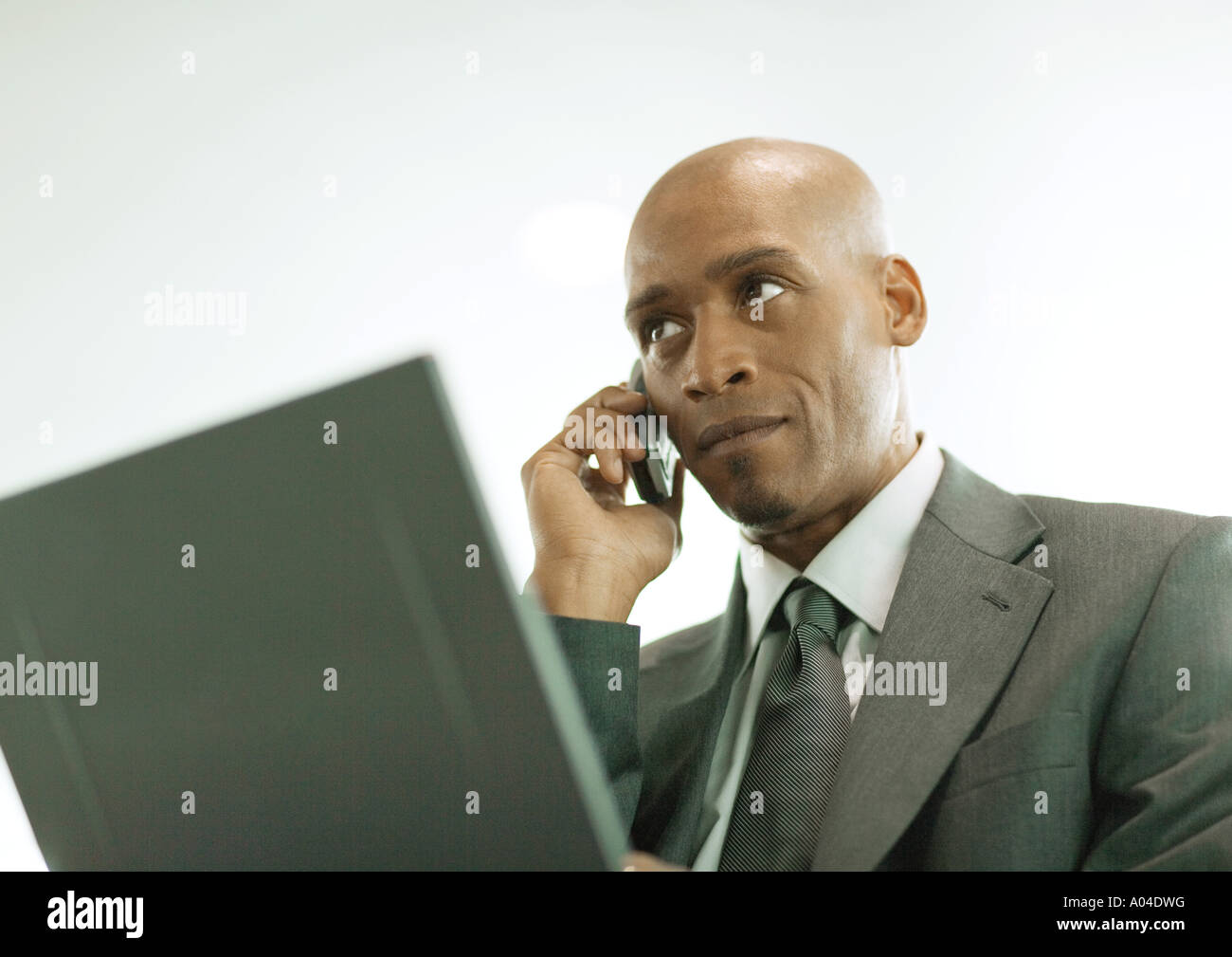 Man using laptop and cell phone Stock Photo
