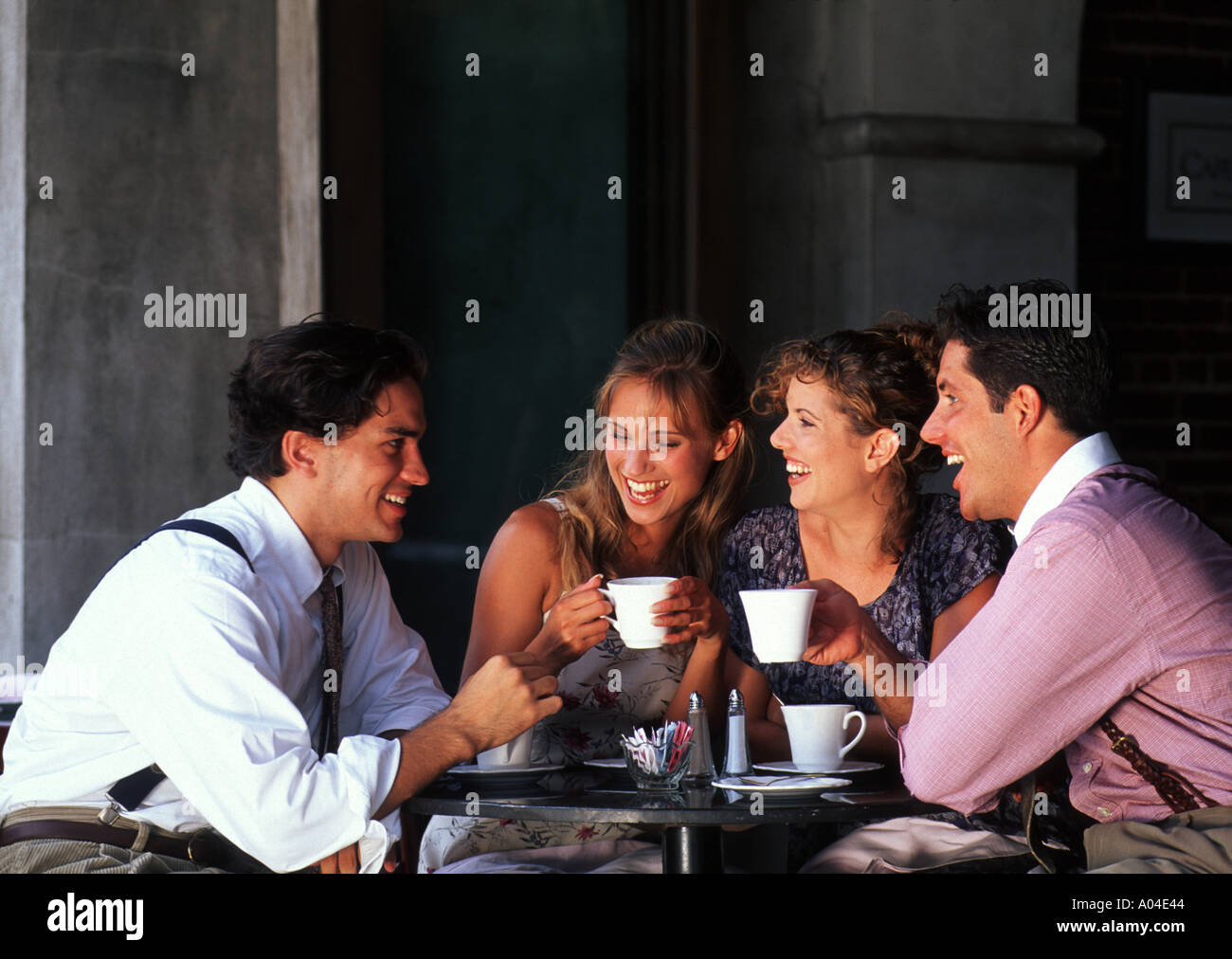 Two young couples age 20s having coffee in cafe Stock Photo