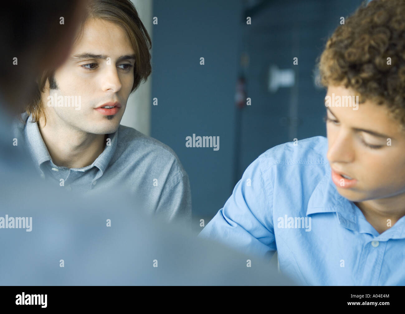 Young businessmen grouped in discussion, selective focus Stock Photo