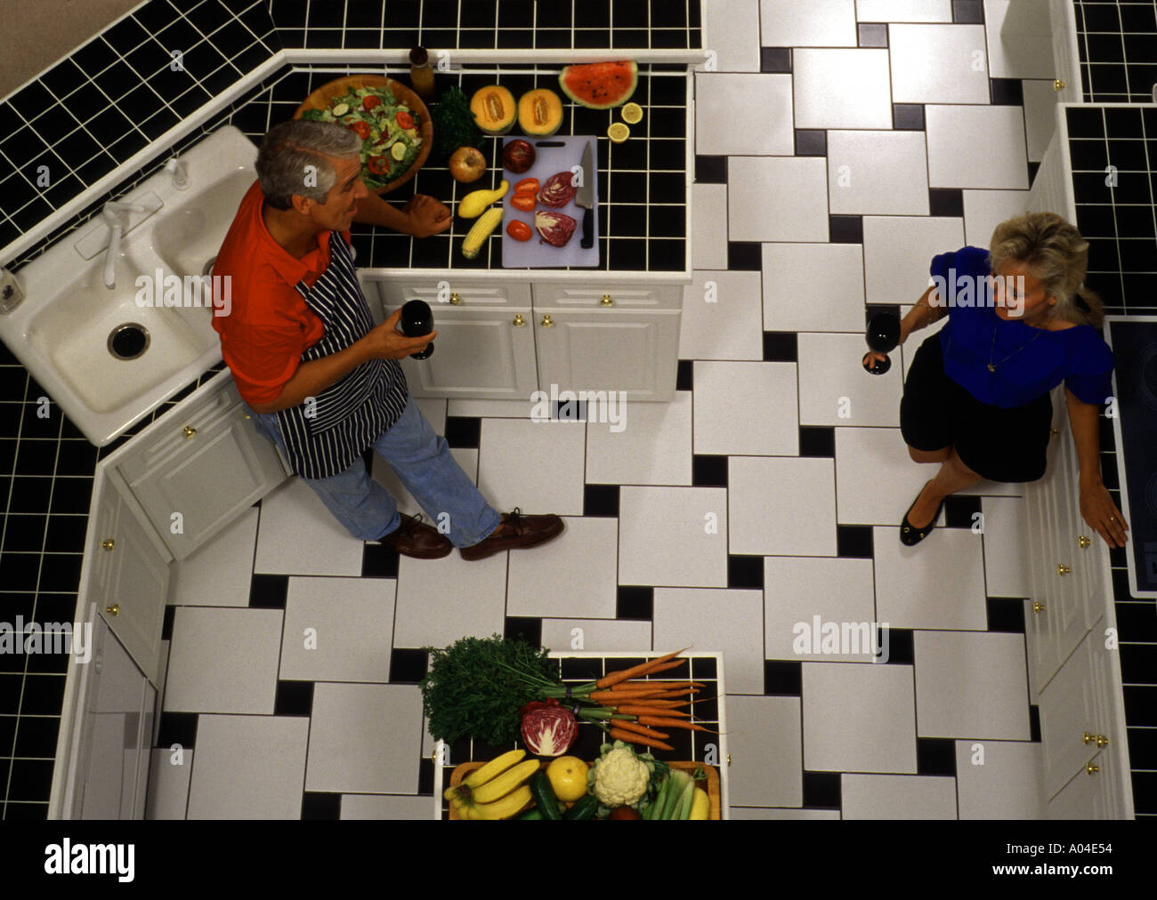 Couple at home cooking in kitchen Stock Photo