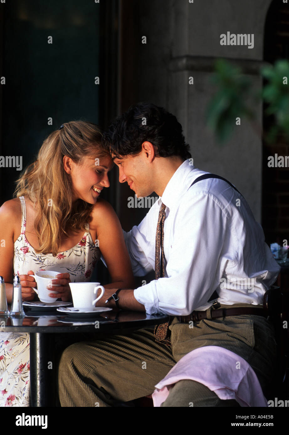 Young couple having affectionate talk in cafe Stock Photo
