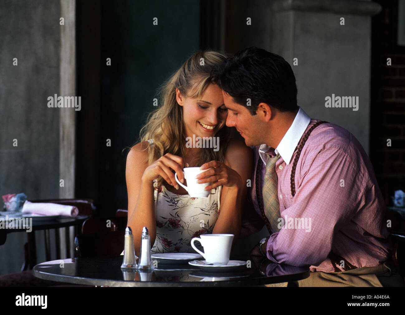 Young couple having affectionate talk in cafe Stock Photo