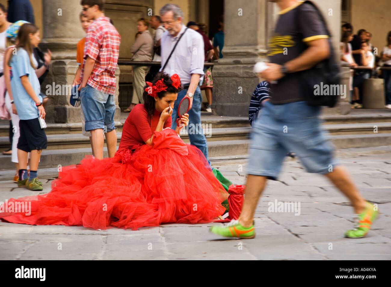Street Drama Dressed in Red, Florence, Italy Stock Photo