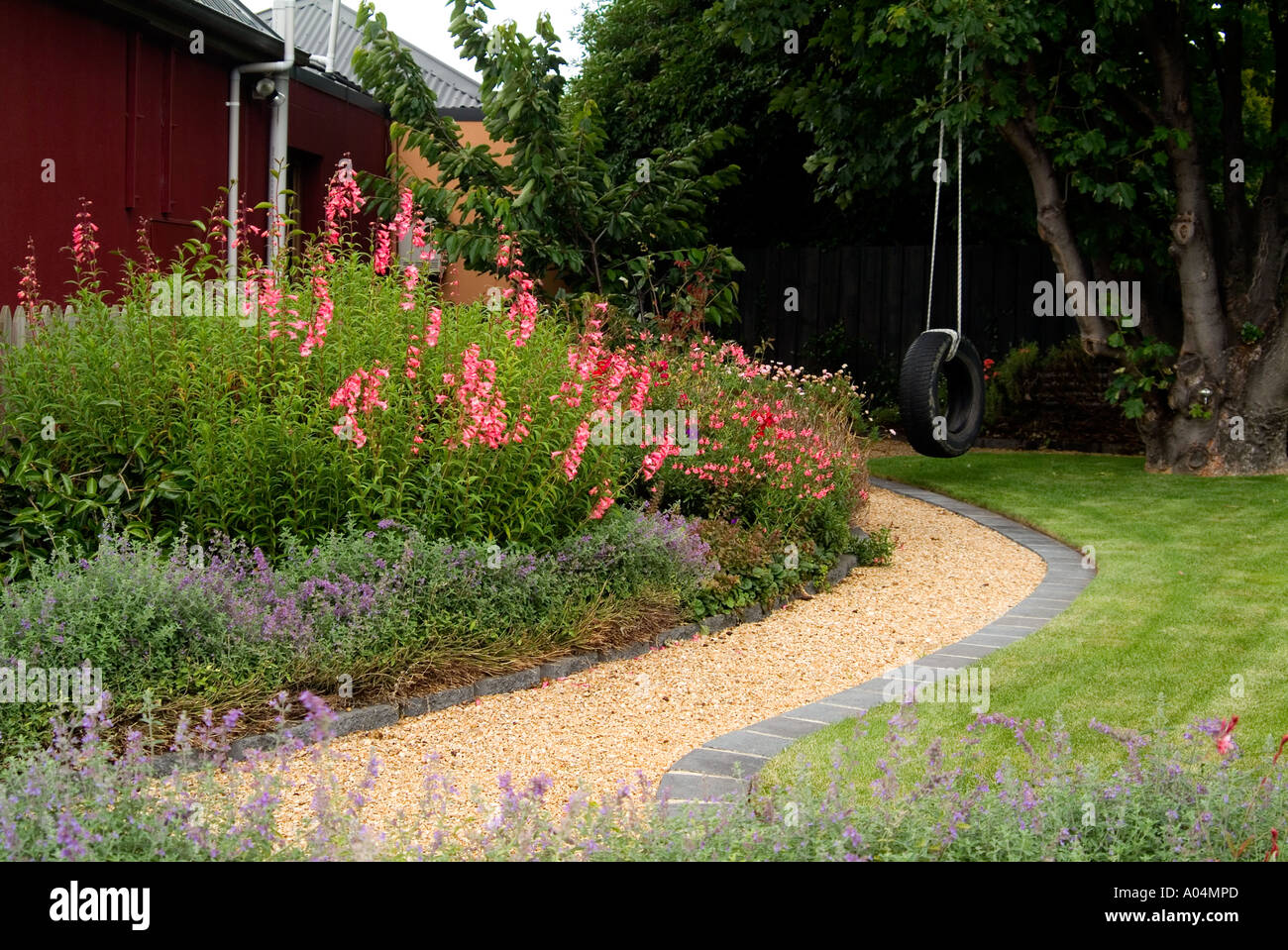 Neat garden path with brick edging Stock Photo
