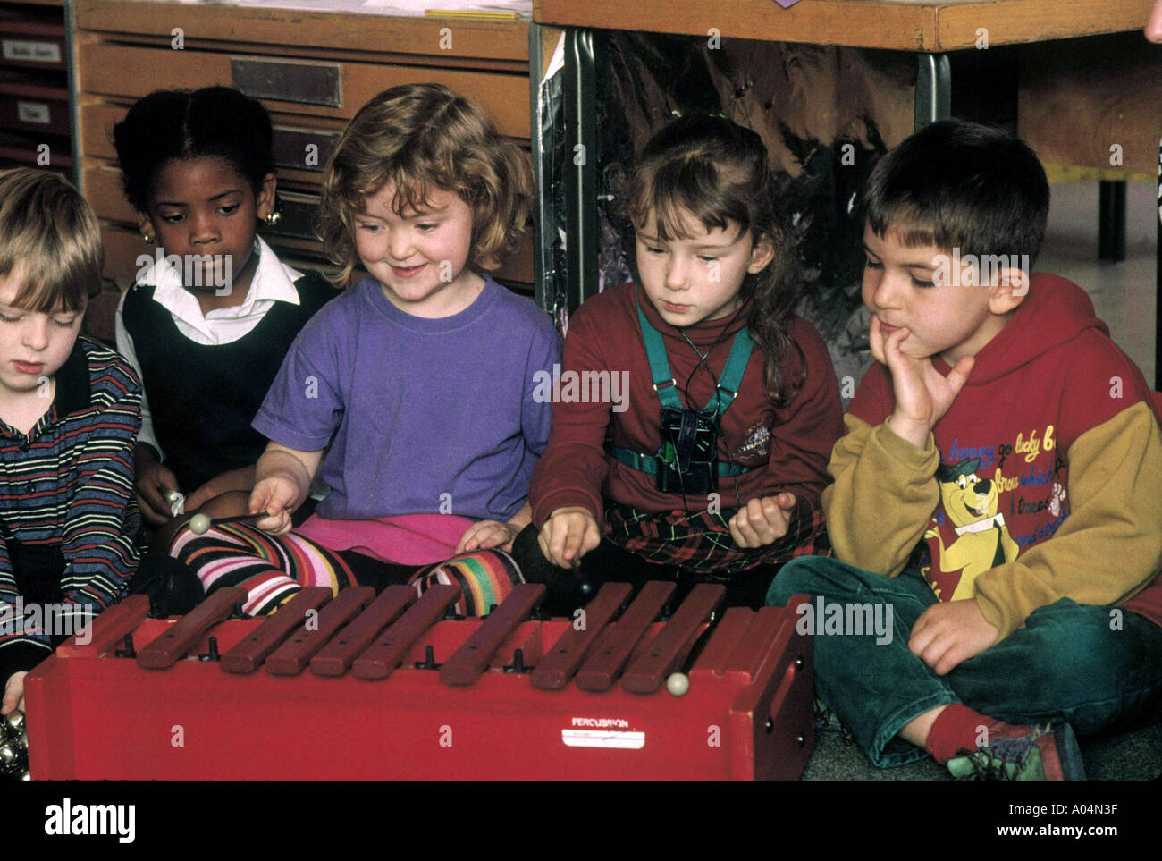 primary school kids in a music class playing the xylophone Stock Photo