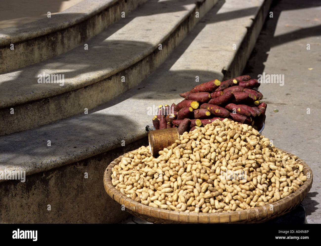 Peanuts and sweet potatoes being sold on a street corner in Dalat, Central Highlands, Vietnam ...