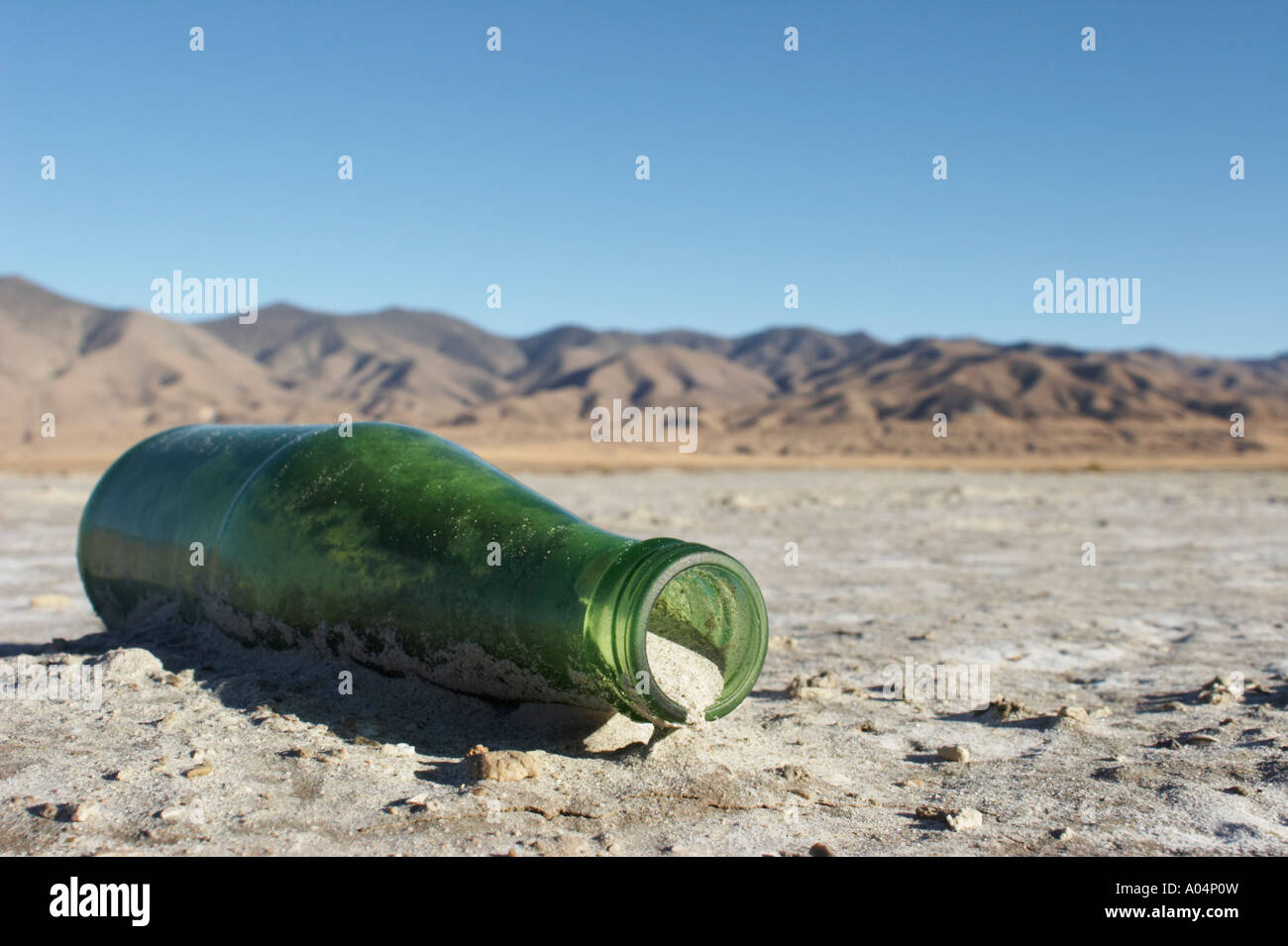 Bottle partially buried in the playa of the Carson Sink, Nevada, USA