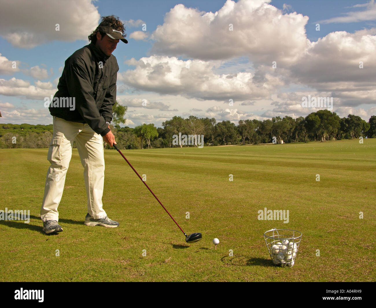 Golf Image of a man using the driver to hit a set of golf balls
