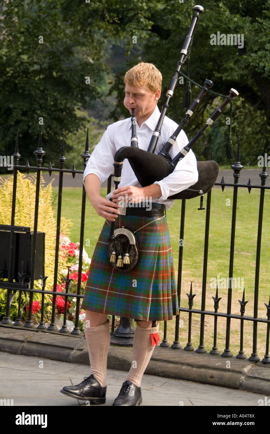 Young man playing bagpipes in capital edinburgh hires stock