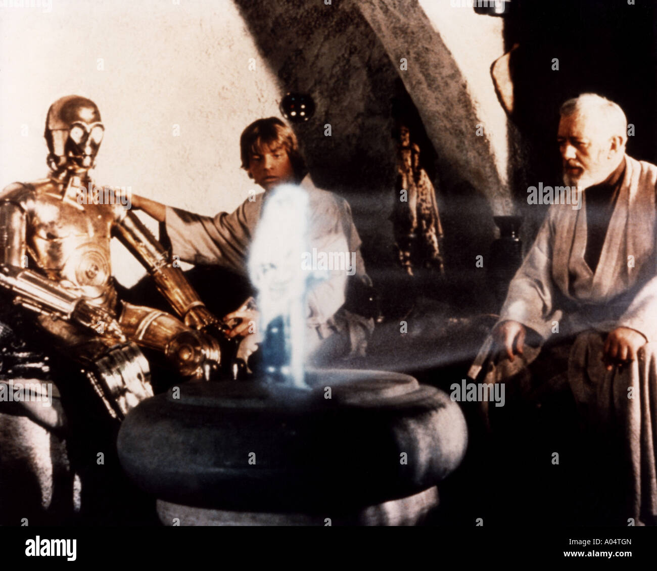STAR WARS 1977 TCF film with from left Anthony Daniels as See Threepio, Mark Hamill and Alec Guinness Stock Photo