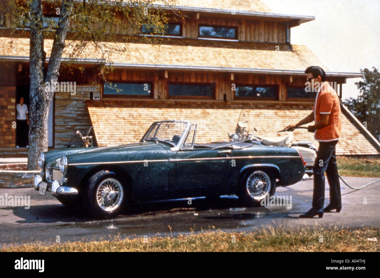 ROY ORBISON US singer washes his MG sports car Stock Photo Alamy