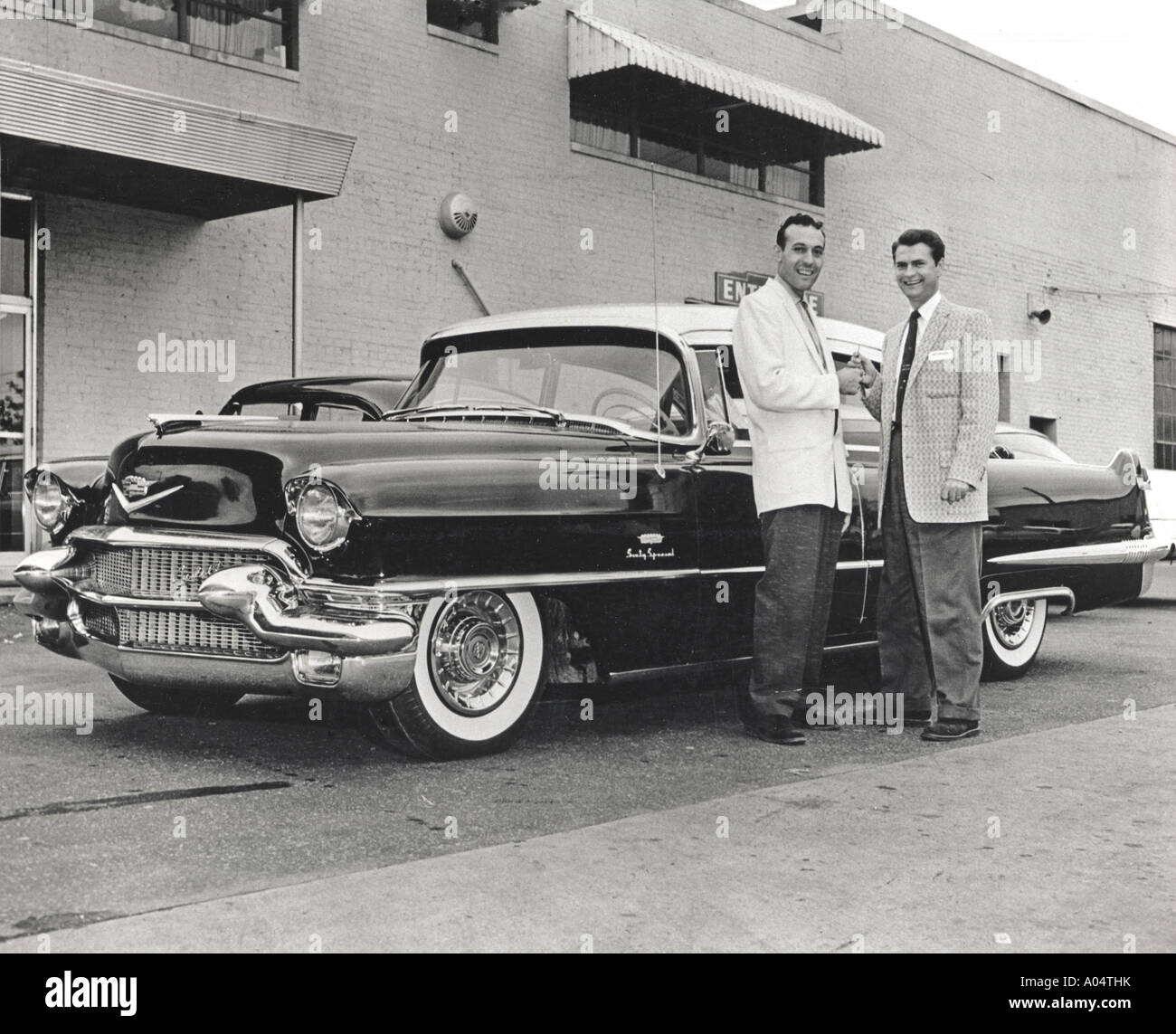 CARL PERKINS receives the keys for his new Cadillac Seventy Special from Sam Phillips his producer behind the Sun Recording Stud Stock Photo