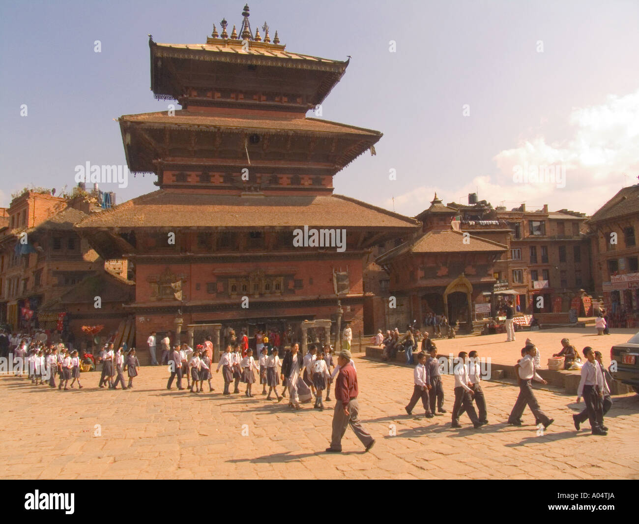 BHAKTAPUR NEPAL November School children walking past Bhairava Temple in Taumadhi Tole in the centre of the old city Stock Photo