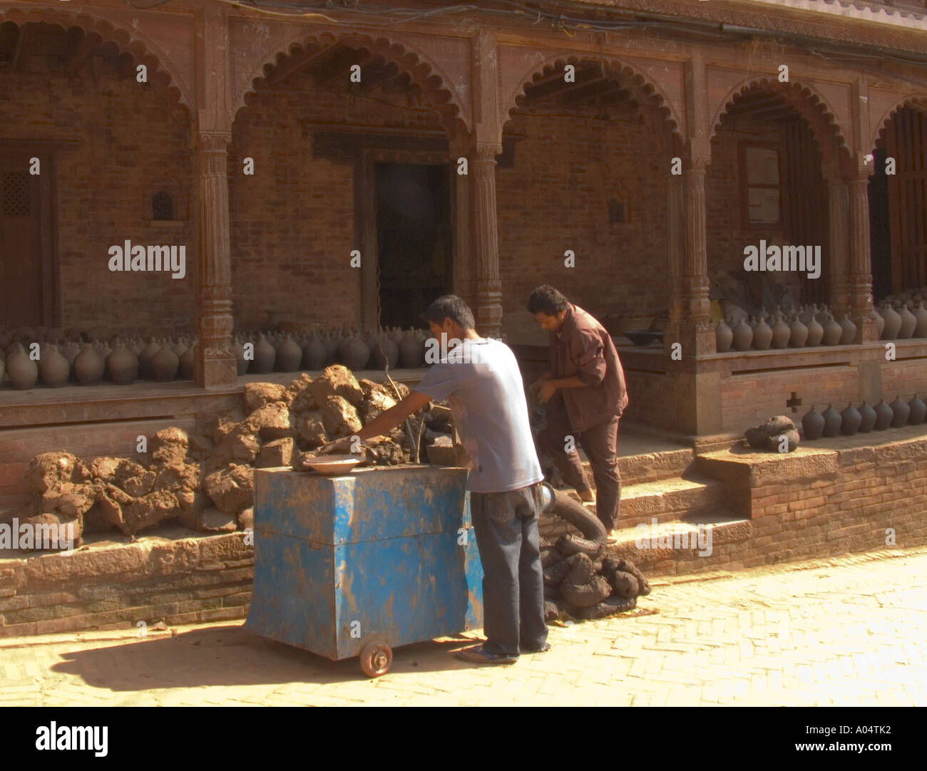 BHAKTAPUR NEPAL November A couple of men producing the clay to make the pots sold to visitors in Potters Square Stock Photo