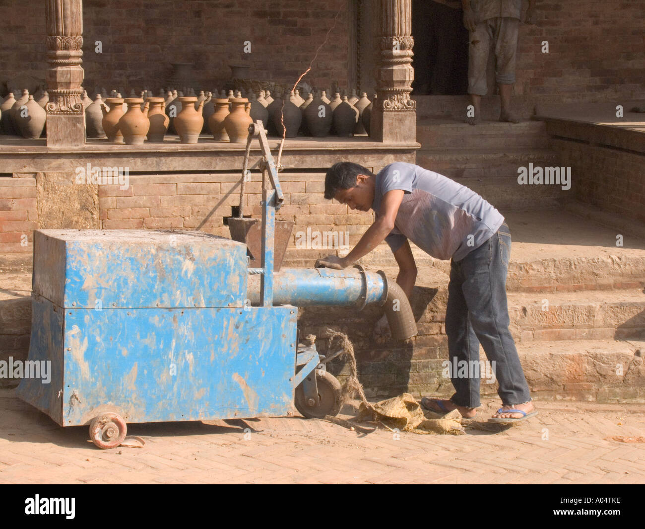 BHAKTAPUR NEPAL November A man producing the clay to make the souvenir pots popular with the many visiting tourists Stock Photo