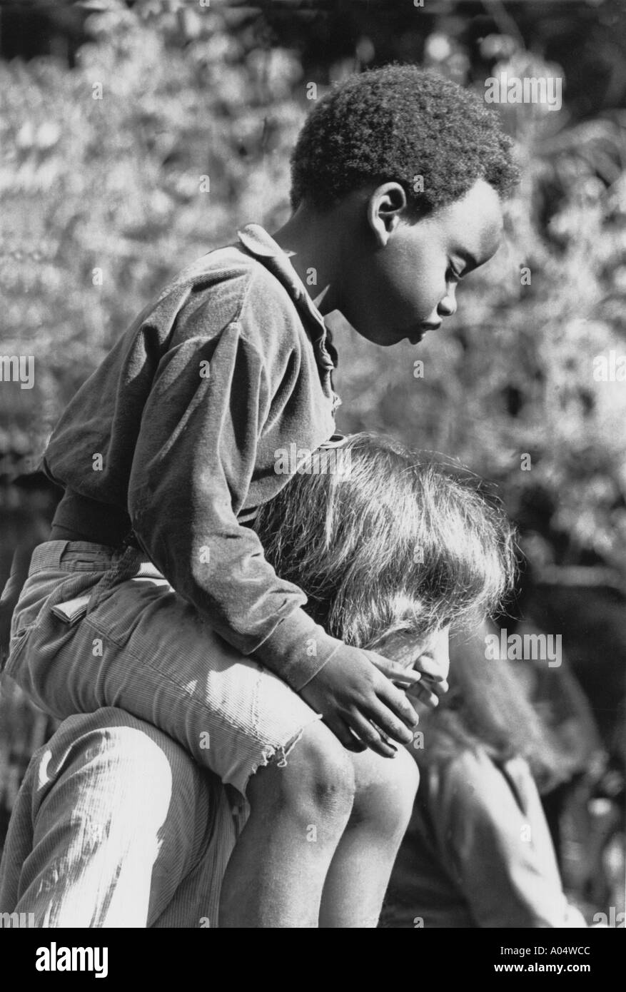 father giving son a piggy back ride. Stock Photo