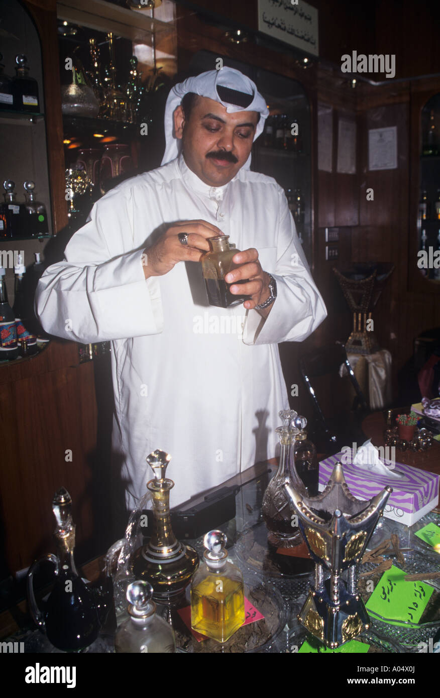 Man testing perfume oils in a shop in Kuwait City Stock Photo Alamy