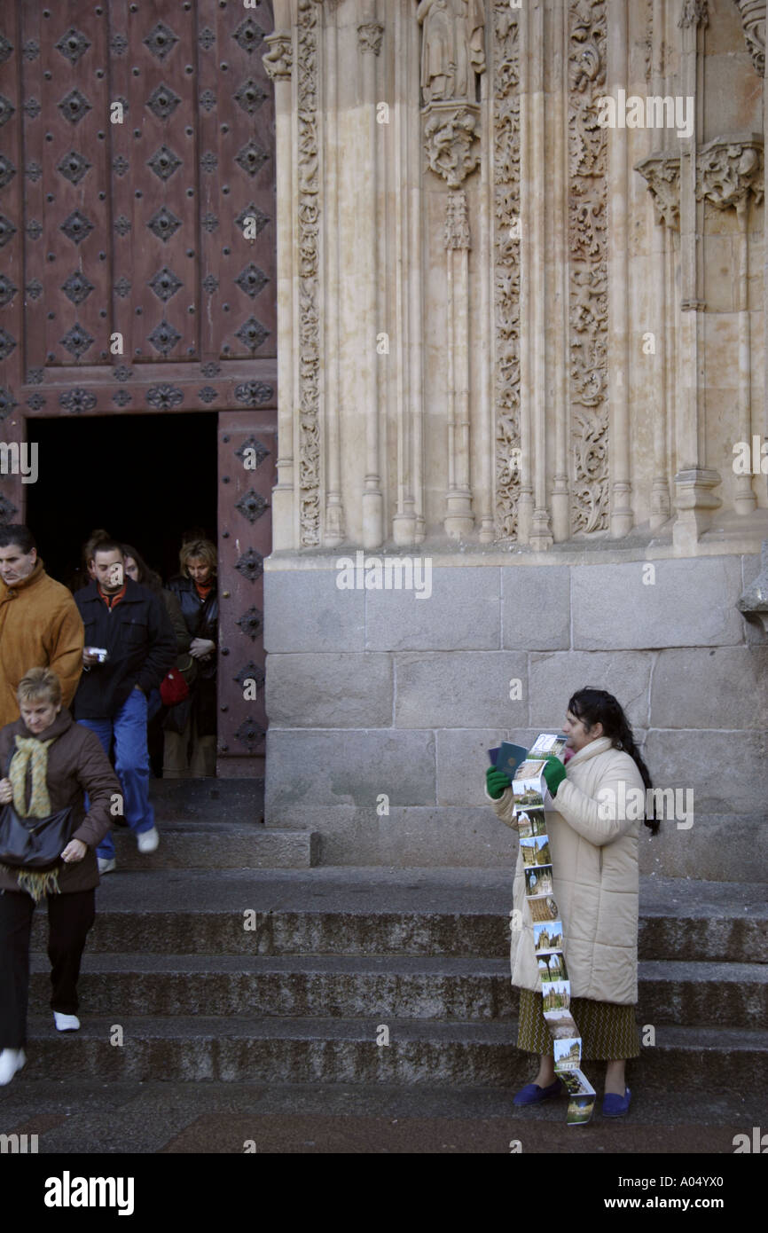 A lady tries to sell postcards to passing tourists Salamanca Spain Stock Photo
