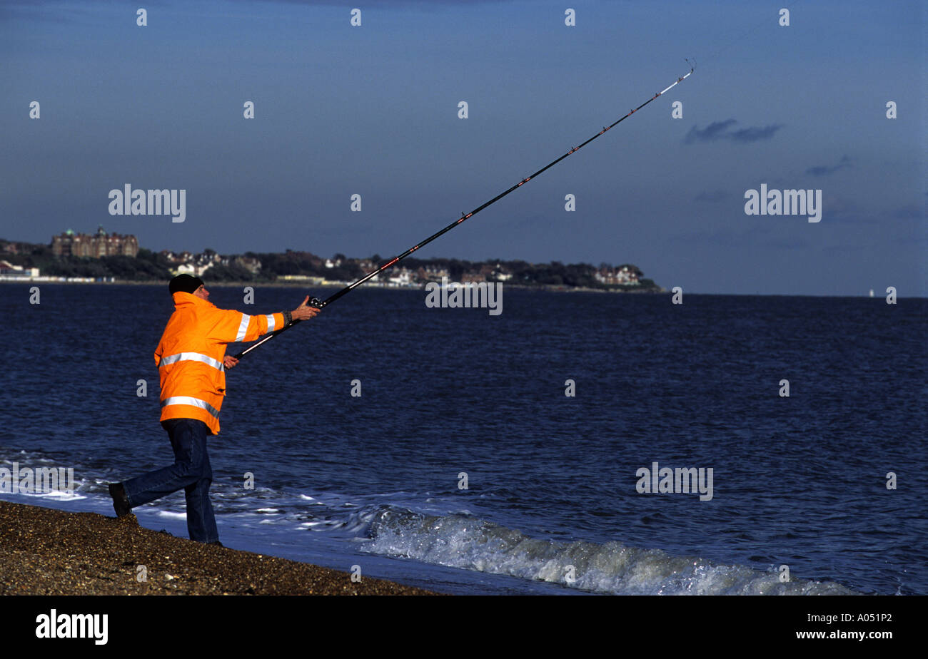 Angler casting his line into the North Sea, Felixstowe, Suffolk, UK. Stock Photo