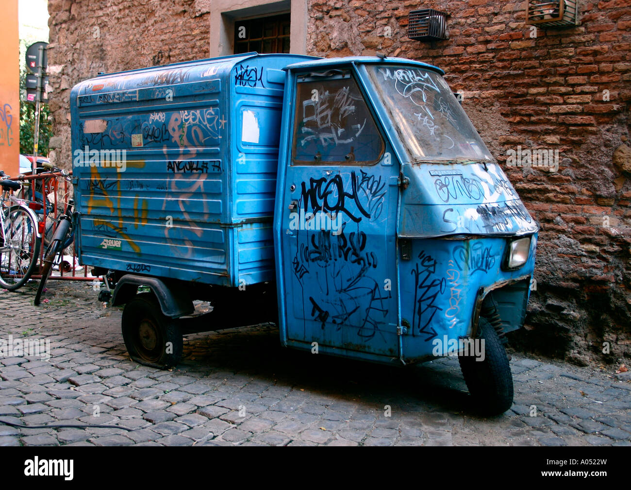 three-wheel van, covered in graffiti, trastevere, rome, italy Stock Photo