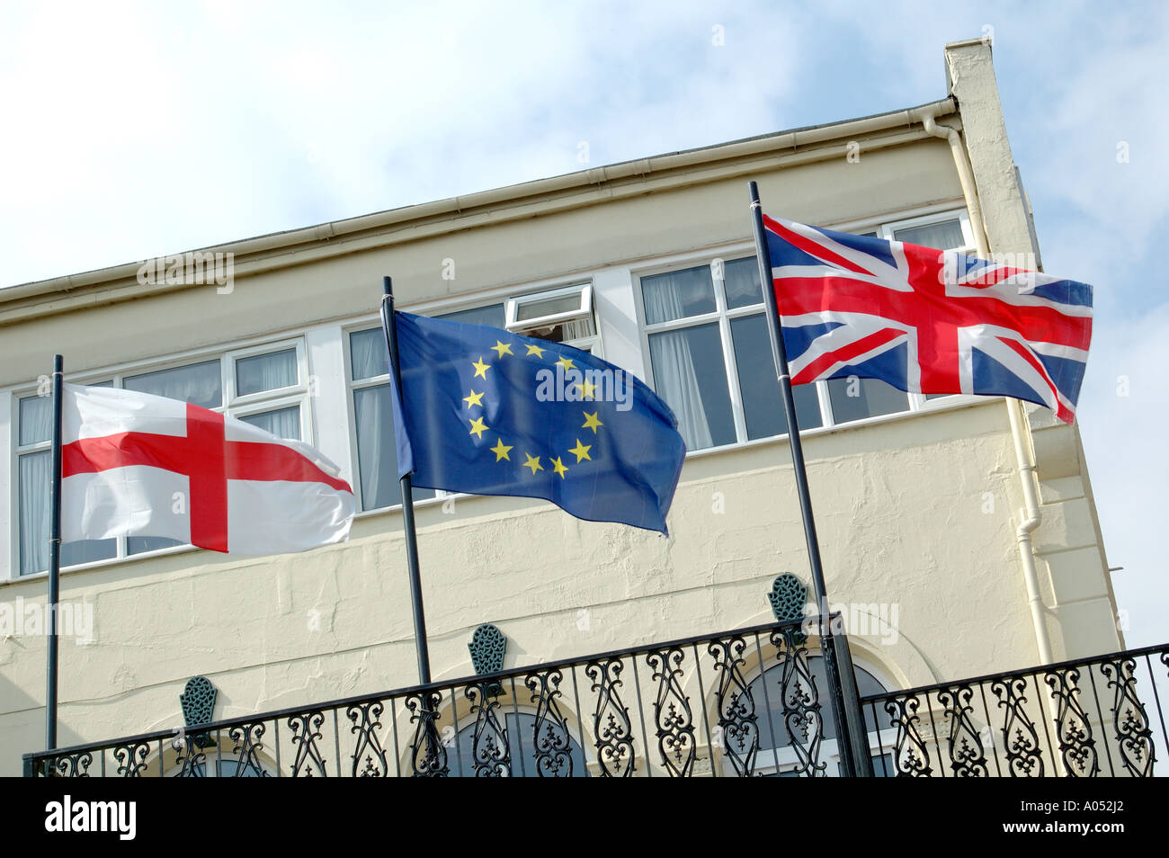 English flag of St George, British Union Flag, and European Union flay flying side by side Stock Photo