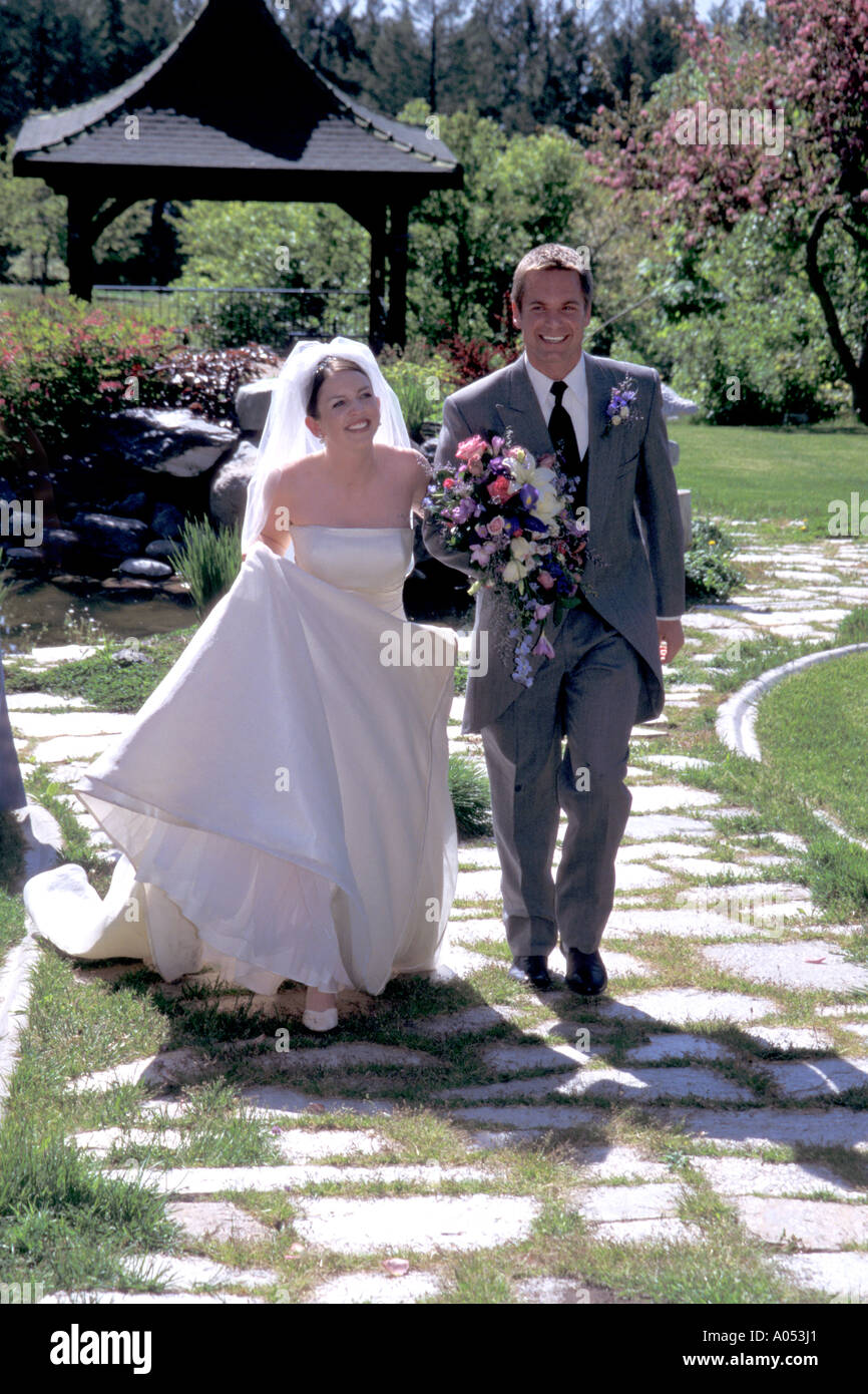 newlyweds at wedding ceremony walking down the aisle with smiles on their faces and in love