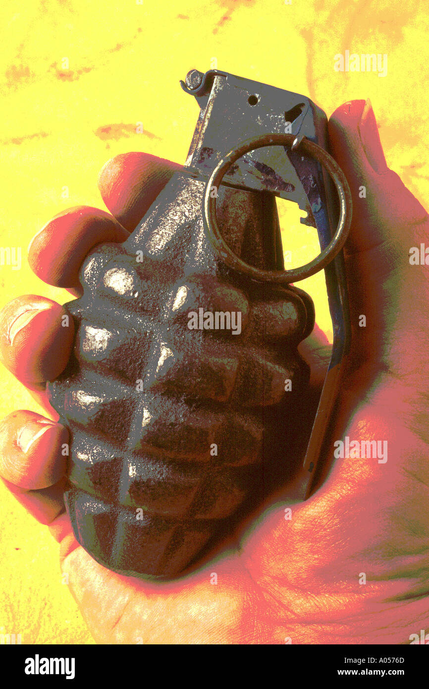 Mans hand holding hand grenade Stock Photo