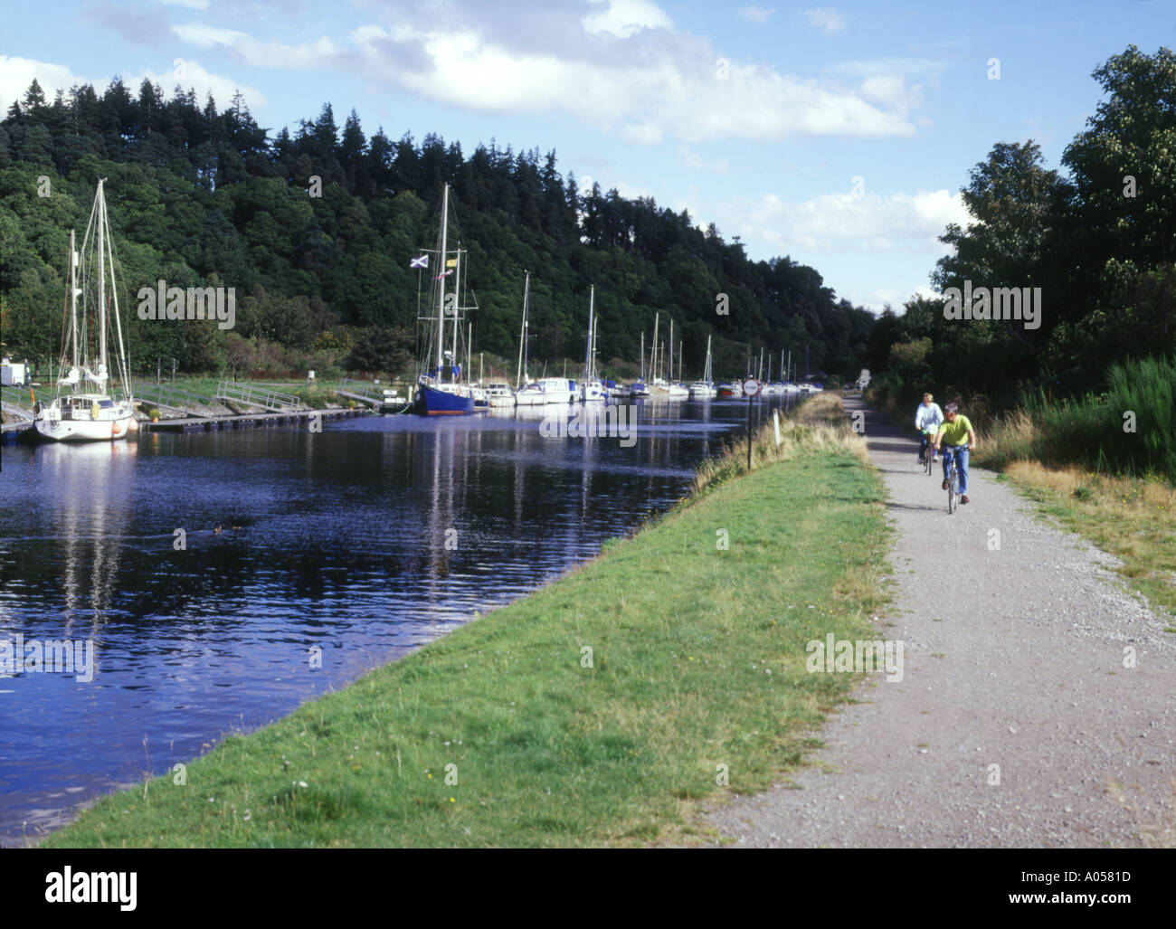 dh Caledonian Canal LOCH NESS INVERNESSSHIRE Bicycle cyclists canal towpath riding bikes cycling child scotland cycle paths bike ride tow path Stock Photo