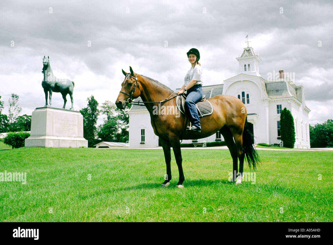 Horse Farm at Middlebury, Vermont, USA. Young woman and horse at