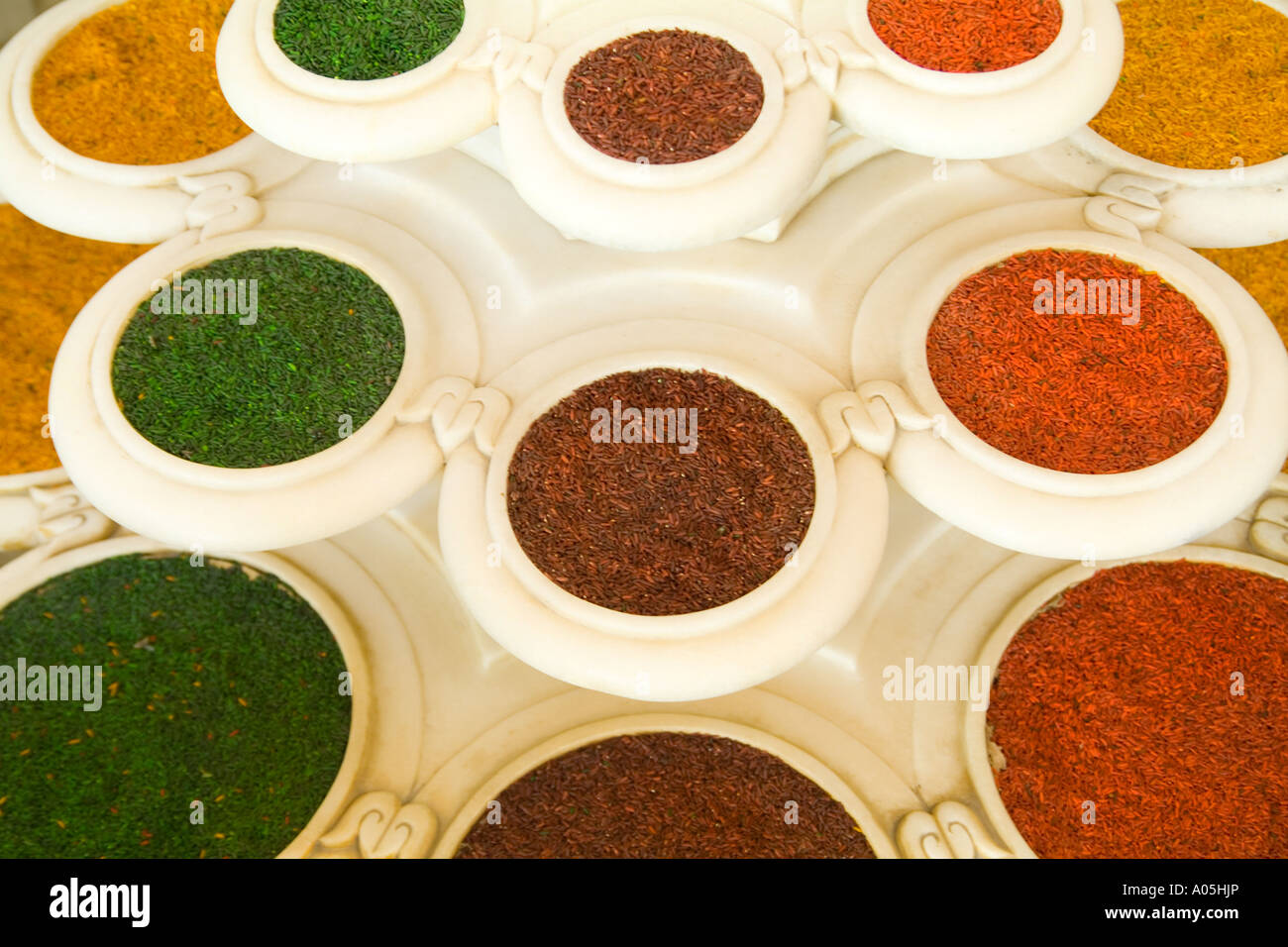 Abstract colorful bowls of spices in vases from above in Agra India ...