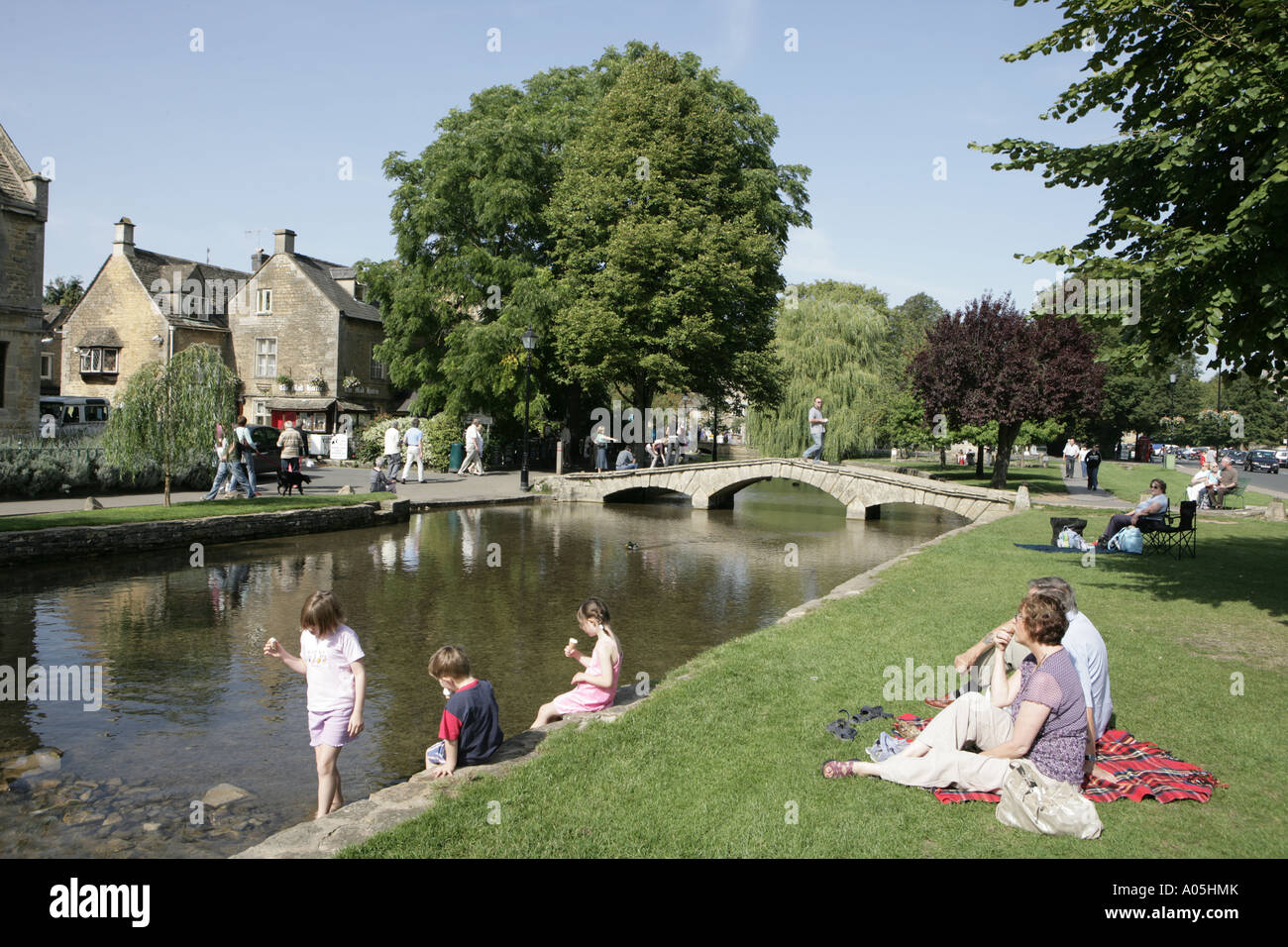 Bourton on the Water the Cotswold town with stone built houses on a sunny day along the river
