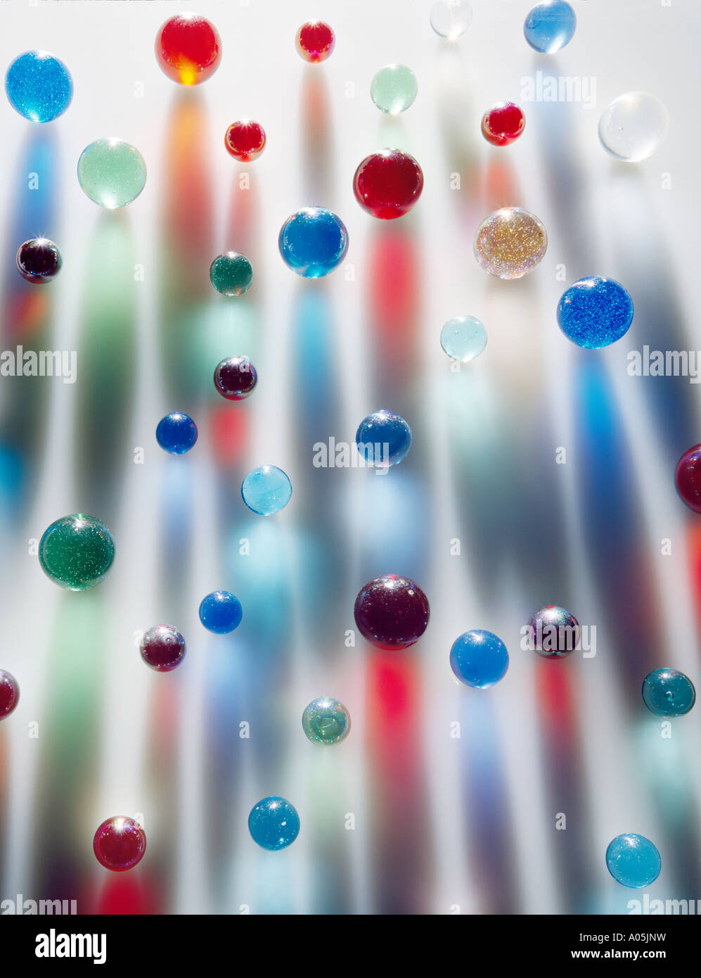 Coloured marbles creating interesting coloured long shadows Stock Photo