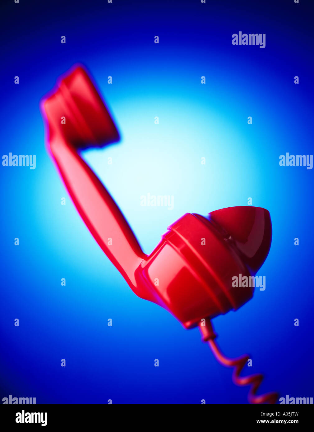 A Red Bakerlite Phone on a blue background Stock Photo