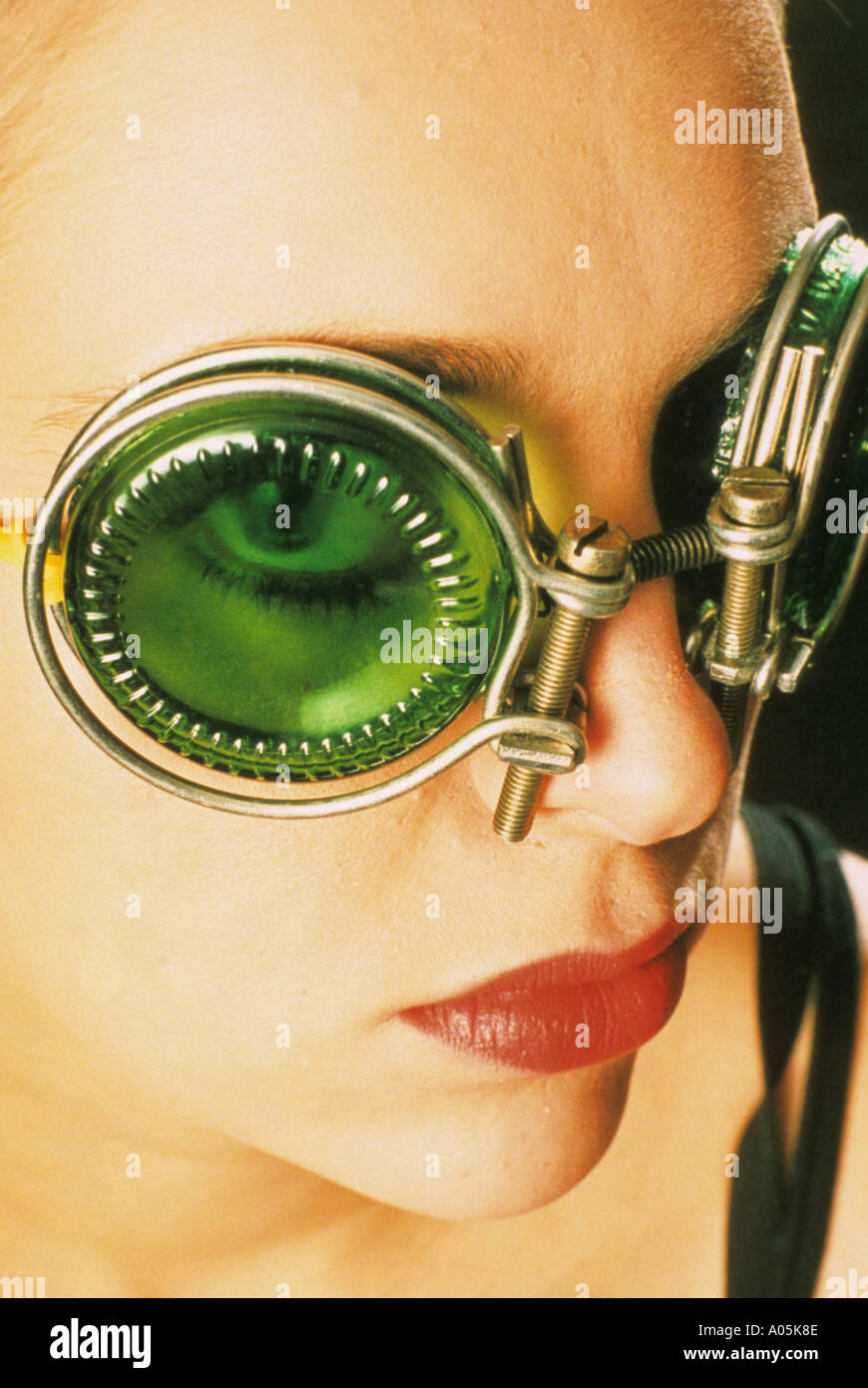 Close up portrait of a woman wearing green tinted fashion googles Stock Photo